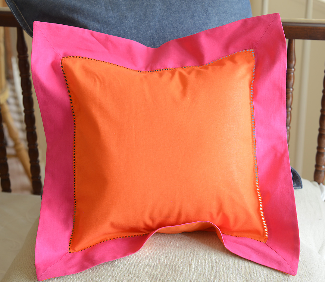 Baby Square Pillow. Multi colored. Frame Orange & Pink Peacock trimmed